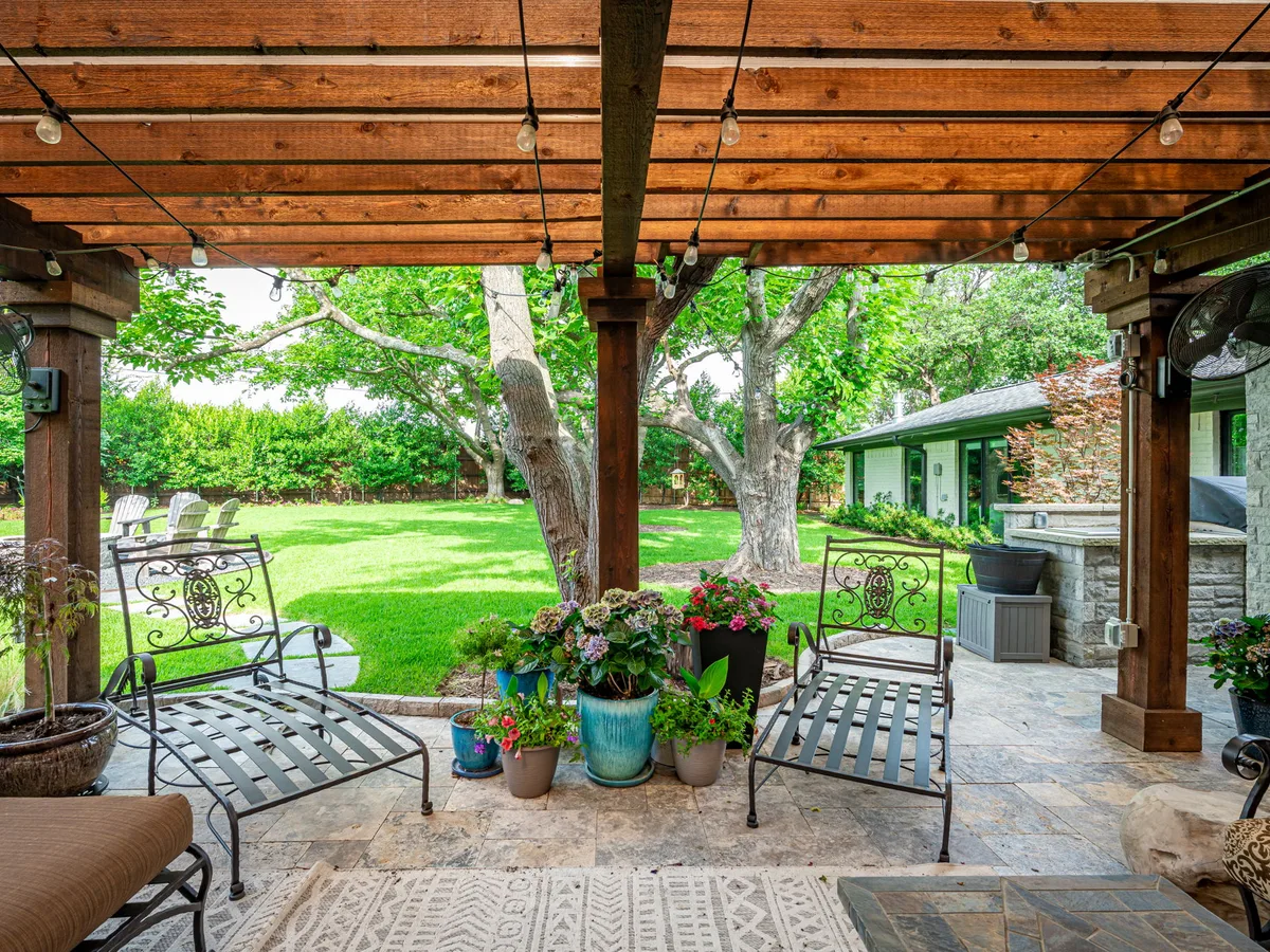 Custom pergola and outdoor living area installed by Stewart Lawncare